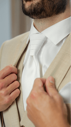 close-up of the groom adjusting his jacket